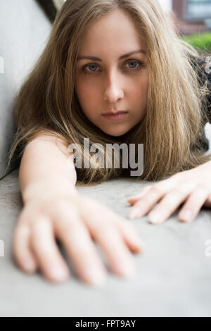 Close up of a serious woman crawling on the ground outdoors Stock Photo