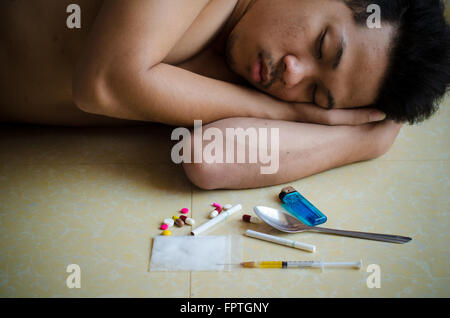 drug addict laying on the floor Stock Photo