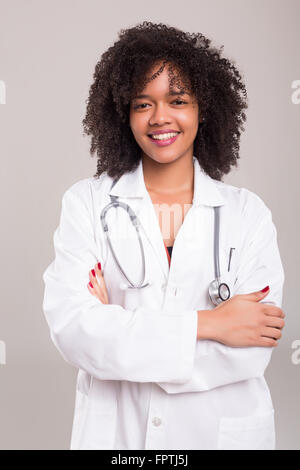 Studio shot of young beautiful African Zulu woman wearing white shirt ...