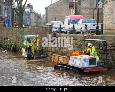 Clearing stones and debris from the floor of the River Calder in Hebden Bridge.  Part of an effort to prevent further flooding. Stock Photo