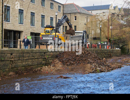 Clearing stones and debris from the floor of the River Calder in Hebden Bridge.  Part of an effort to prevent further flooding. Stock Photo