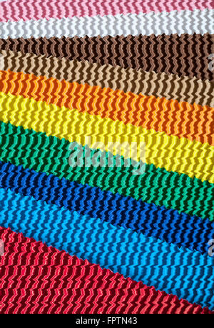 abstract waves of diagonal lines of colourful corrugated cardboard Stock Photo
