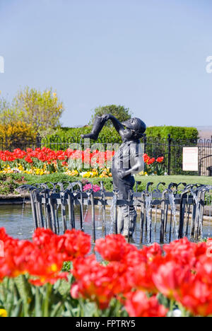 Cleethorpes, Lincolnshire, UK - 18 April 2014: Boy with Leaking Boot on 18 April at Princess of Wales Memorial Garden, Kingsway Stock Photo