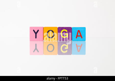 Yoga - an inscription from children's wooden blocks Stock Photo