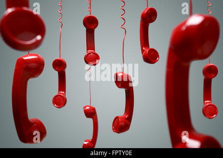 Red telephone receiver hanging Stock Photo