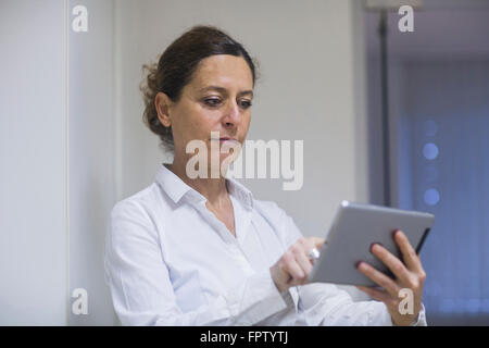 Female physiotherapist using a digital tablet, Freiburg Im Breisgau, Baden-Württemberg, Germany Stock Photo