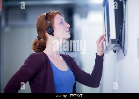 Young female engineer working on touchscreen computer monitor in an industry, Freiburg Im Breisgau, Baden-Württemberg, Germany Stock Photo