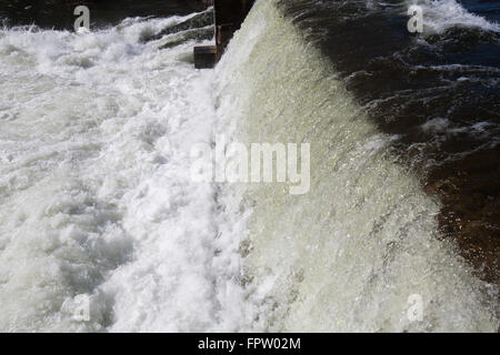 Water flowing over a dam. Stock Photo