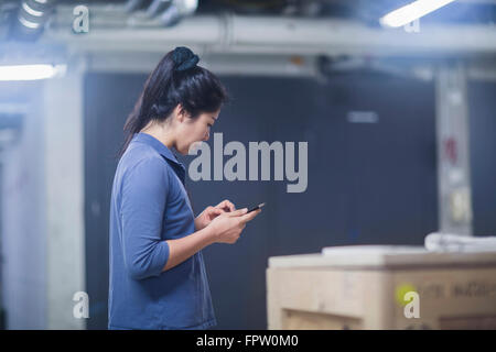 Young female engineer using a digital tablet in an industrial plant, Freiburg Im Breisgau, Baden-Württemberg, Germany Stock Photo