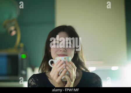 Portrait of a businesswoman having a cup of coffee in an office, Freiburg Im Breisgau, Baden-Württemberg, Germany Stock Photo