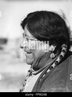 1930s PORTRAIT PROFILE SMILING NATIVE AMERICAN MAN WEARING EARRING & BRAIDS SAN ILDEFONSO PUEBLO NEW MEXICO USA Stock Photo