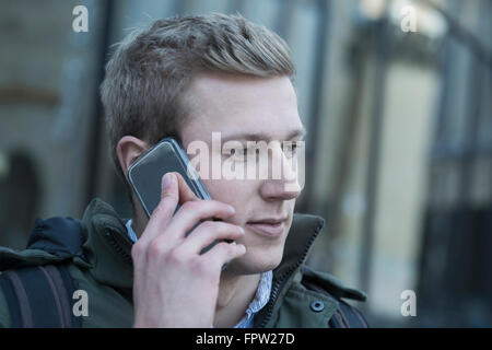 College student talking on a mobile phone, Freiburg im Breisgau, Baden-Württemberg, Germany Stock Photo