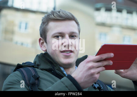 Portrait of a young student using digital tablet, Freiburg im Breisgau, Baden-Württemberg, Germany Stock Photo