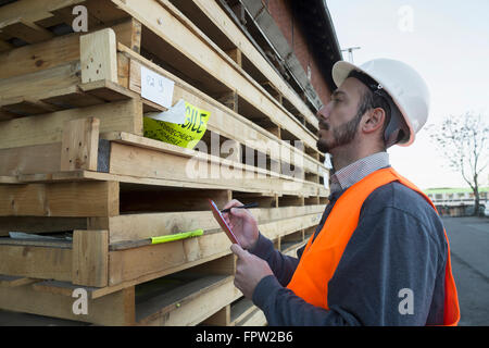 Young male engineer working at construction site, Freiburg Im Breisgau, Baden-Württemberg, Germany Stock Photo
