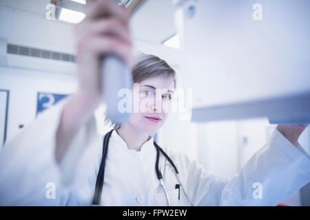 Young female doctor using x-ray machine in hospital, Freiburg im Breisgau, Baden-Württemberg, Germany Stock Photo