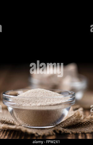 Yeast (fresh and dried)on vintage wooden background (close-up shot) Stock Photo