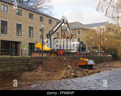 Clearing stones and debris from the floor of the River Calder in Hebden Bridge.  Part of an effort to prevent further flooding. Stock Photo