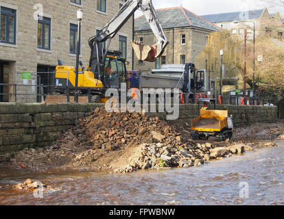 Clearing stones and debris from the floor of the River Calder in Hebden Bridge.  Part of an effort to prevent further flooding. Stock Photo