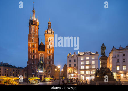 Night falls at St Mary's church on the Main Market Square in Krakow Old Town, Poland. Stock Photo