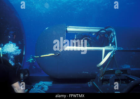 SEAL Delivery Vehicle (SDV) pilot and navigator conduct predive preparations inside the SDV as the Dry Deck Shelter operators on Stock Photo