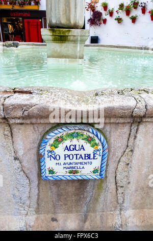 Fountain with water not suitable for drinking sign Agua no Potable, Orange Square, old town of Marbella Andalusia, Spain Stock Photo