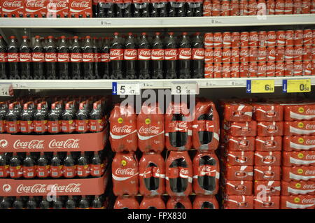 Bottles and cans of CocaCola in a supermarket Stock Photo  Alamy