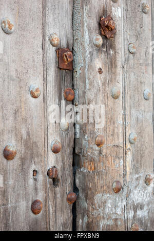 Details of old wood and rusty metal on an old door. Image is perfect for a background. Stock Photo