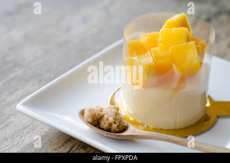 Mango cheesecake on white plate Stock Photo
