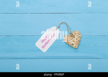 Natural straw heart with Mother's day card on blue background Stock ...