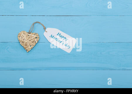 Natural straw heart with Mother's day card on blue background Stock ...