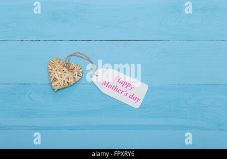 Natural straw heart with Mother's day card on blue background Stock ...