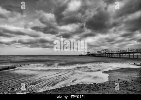 Beautiful sunset landscape image of pier at sea in Worthing England Stock Photo