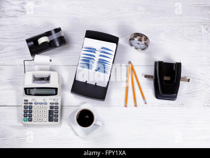 Overhead view of vintage white desktop with outdated office stationery. Stock Photo