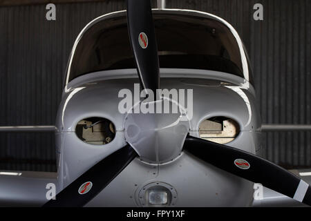 Cirrus SR20 light aircraft nicely contoured silhouette in a hangar Stock Photo