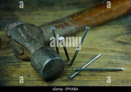 Hammer and nails on wood plank Stock Photo