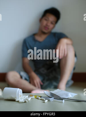 drugs and drug addict, sitting in the background Stock Photo