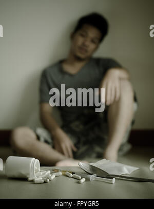 drugs and drug addict, sitting in the background Stock Photo