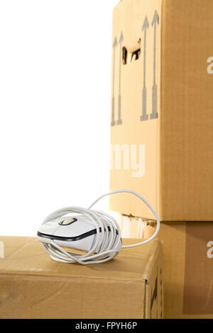 Computer mouse on moving boxes over white background - office moving or relocation concept Stock Photo