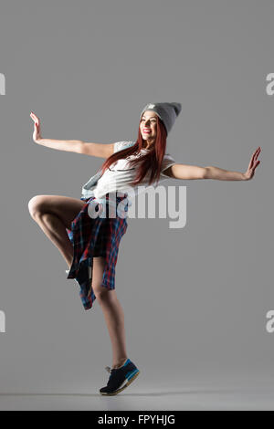 Portrait of one attractive happy fit cute hipster young woman wearing casual clothing and beanie dancing. Modern style beautiful Stock Photo