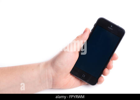 Paris, France, October 31, 2015: Woman holding in the hand an  black iPhone 6 isolated on a white background Stock Photo