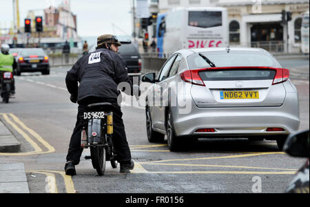 Brighton, UK. 20th March, 2016. Robert Hummerstone pushes off into traffic on his 1914 Sun as he takes part in the 77th Pioneer Run for Veteran Motorcycles which starts in Epsom Surrey and finishes on Brighton seafront  Credit:  Simon Dack/Alamy Live News Stock Photo