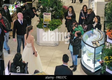 New York, USA. 20th March, 2016. Macy's transcontinental journey in flowers draws crowds. A wedding dress model graced the main floor. Credit:  Patti McConville/Alamy Live News Stock Photo