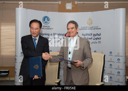 (160320) -- DOHA, March 20, 2016 (Xinhua) -- Xinhua News Agency President Cai Mingzhao(L) shakes hands with director-general of Al Jazeera Media Network Mostefa Souag after they signed a bilateral agreement of strategic cooperation in Doha, capital of Qatar, March 20, 2016. Xinhua News Agency President Cai Mingzhao on Sunday signed a bilateral agreement of strategic cooperation with the director-general of Al Jazeera Media Network here ahead of the World Media Summit (WMS) 2016. According to the agreement, the two organizations will expand their cooperation in areas of news information coopera Stock Photo