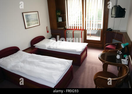 POPRAD, SLOVAKIA - MAY 01, 2014: Room with two beds and chairs in slovakian hotel. Stock Photo