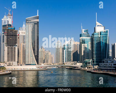 Highrise waterfront buildings, boats and bridge in the Marina district of Dubai, United Arab Emirates Stock Photo