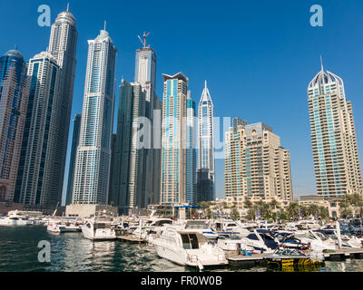 Motor yachts and highrise waterfront buildings in the Marina district of Dubai, United Arab Emirates