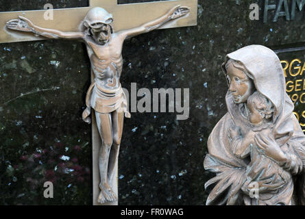 Virgin Mary with baby Jesus looks at Jesus crucified on the cross, Cemetery in Hohenberg, Germany Stock Photo