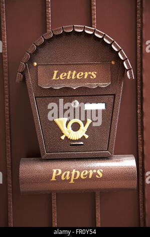 New and beautiful mail box on a metal gate Stock Photo