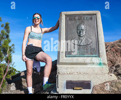 Hiker by the plaque atop Sandstone Peak (Mt. Allen), the highest point in the Santa Monica Mountains Stock Photo
