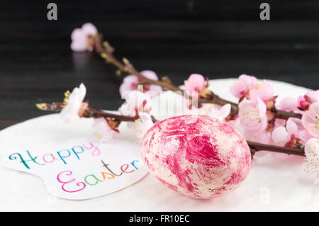 Decorated Easter eggs and fresh cherry blossom tree Stock Photo